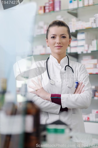 Image of pharmacist chemist woman standing in pharmacy drugstore