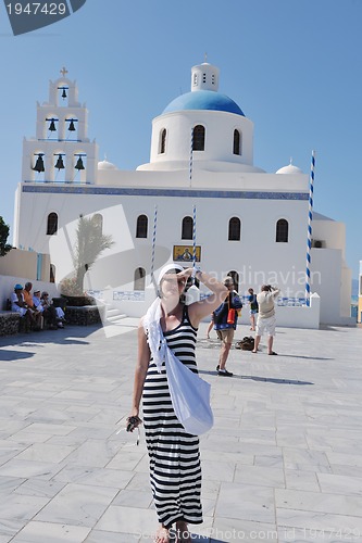 Image of Greek woman on the streets of Oia, Santorini, Greece