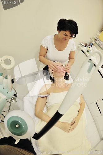 Image of woman with facial mask in cosmetic studio