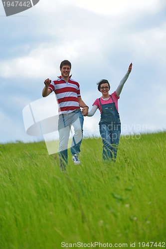 Image of Portrait of romantic young couple smiling together outdoor