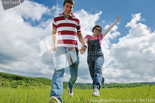 Image of Portrait of romantic young couple smiling together outdoor