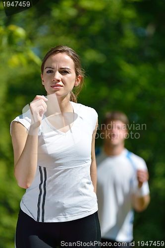 Image of Young couple jogging at morning