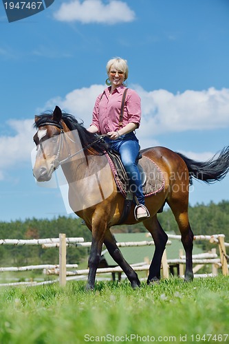 Image of happy woman  on  horse