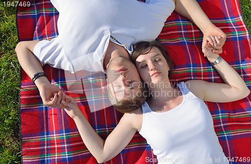 Image of happy young couple having a picnic outdoor