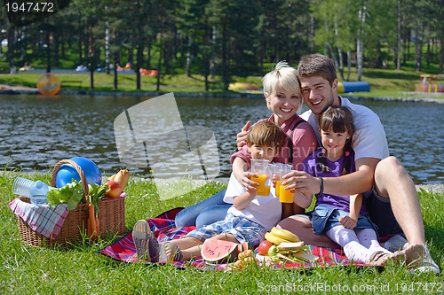 Image of Happy family playing together in a picnic outdoors