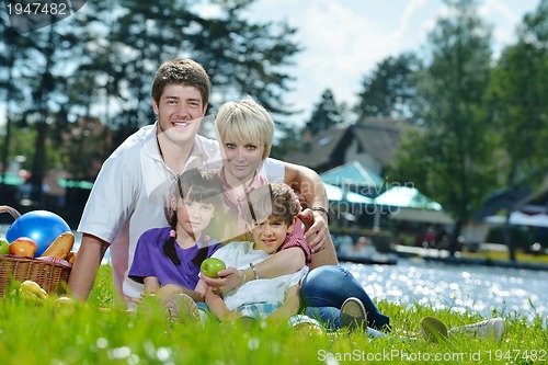 Image of Happy family playing together in a picnic outdoors