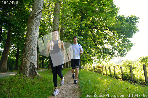 Image of Young couple jogging