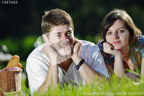 Image of happy young couple having a picnic outdoor