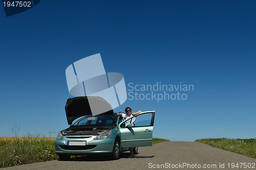 Image of woman with broken car