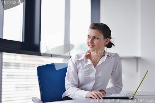 Image of Young pretty business woman with notebook in the office