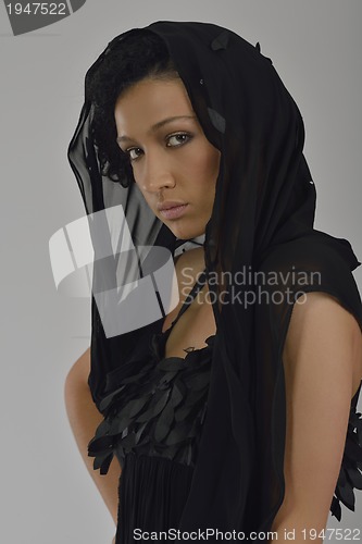 Image of elegant woman in fashionable dress posing in the studio