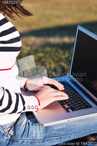 Image of young teen girl work on laptop outdoor