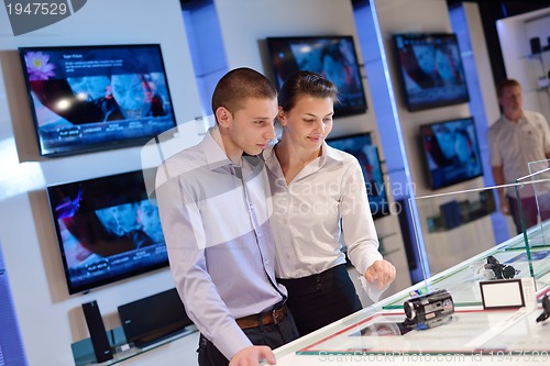 Image of Young couple in consumer electronics store