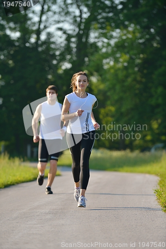 Image of Young couple jogging at morning