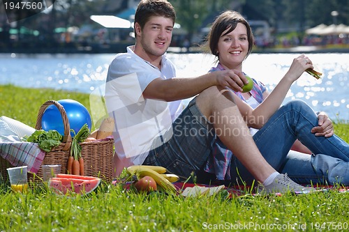 Image of happy young couple having a picnic outdoor