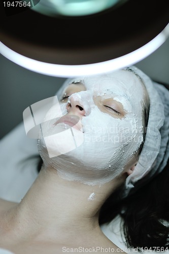 Image of woman with facial mask in cosmetic studio