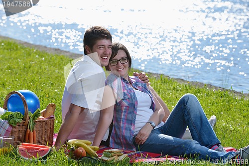 Image of happy young couple having a picnic outdoor