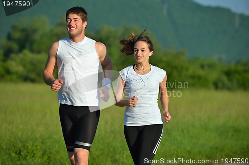 Image of Young couple jogging