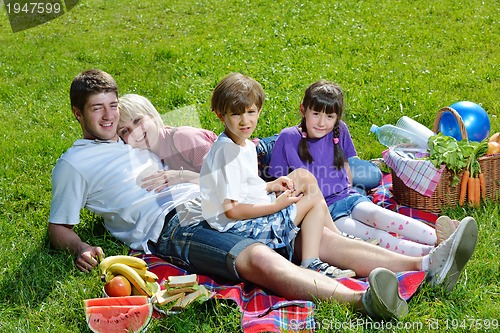 Image of Happy family playing together in a picnic outdoors