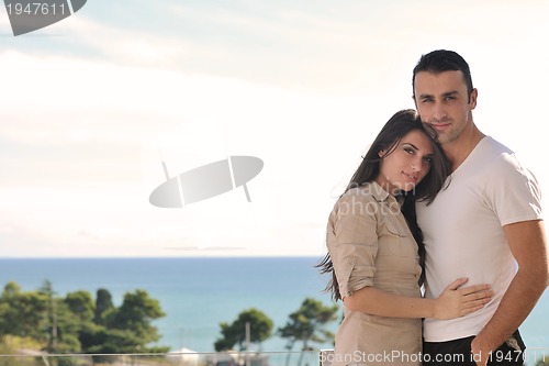 Image of couple relaxing on balcony