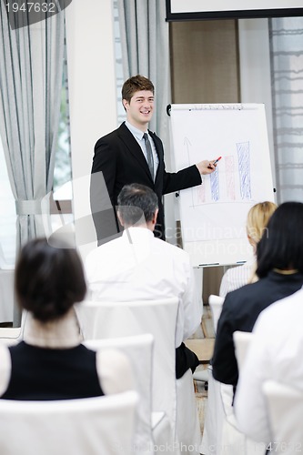 Image of Young  business man giving a presentation on conference