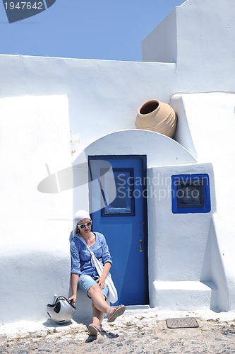 Image of Greek woman on the streets of Oia, Santorini, Greece