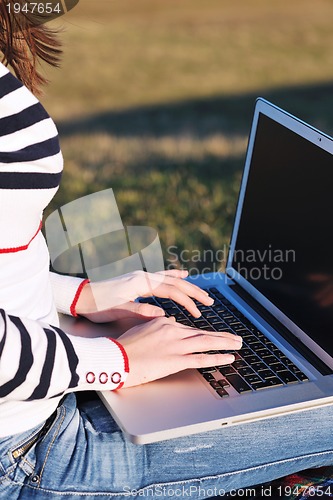Image of young teen girl work on laptop outdoor