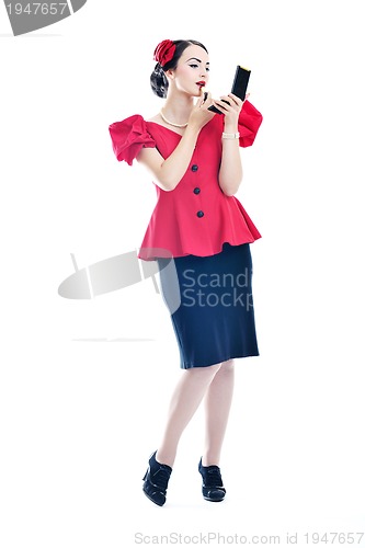 Image of beautiful young woman applying makeup