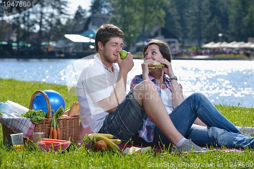 Image of happy young couple having a picnic outdoor