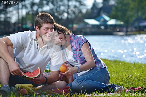 Image of happy young couple having a picnic outdoor