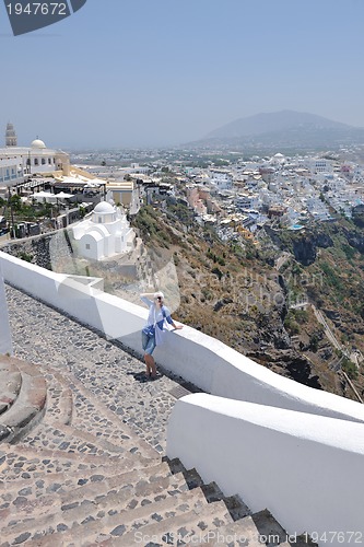 Image of Greek woman on the streets of Oia, Santorini, Greece