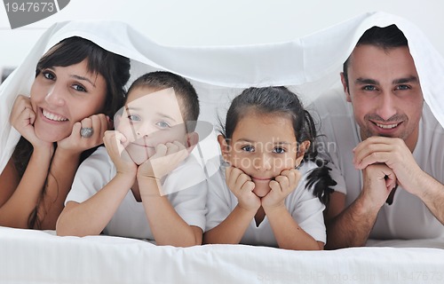 Image of happy young Family in their bedroom