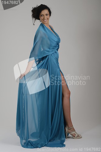 Image of elegant woman in fashionable dress posing in the studio