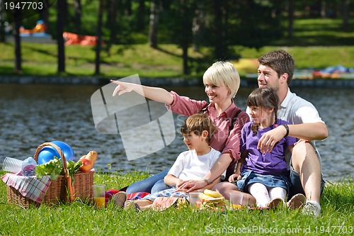 Image of Happy family playing together in a picnic outdoors
