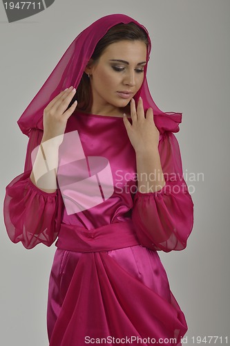 Image of elegant woman in fashionable dress posing in the studio