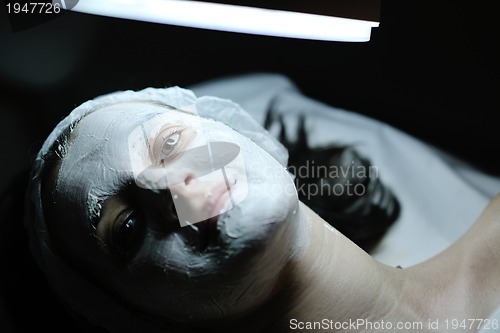 Image of woman with facial mask in cosmetic studio