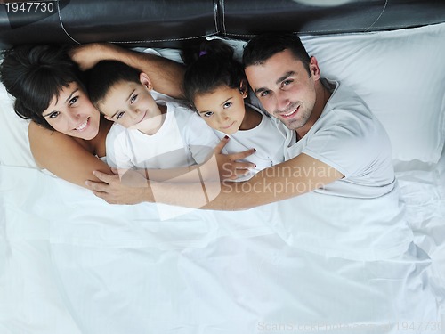 Image of happy young Family in their bedroom