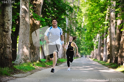 Image of Young couple jogging