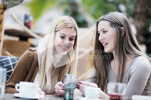 Image of cute smiling women drinking a coffee