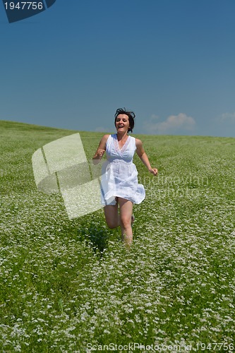 Image of Young happy woman in green field