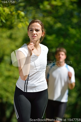 Image of Young couple jogging at morning