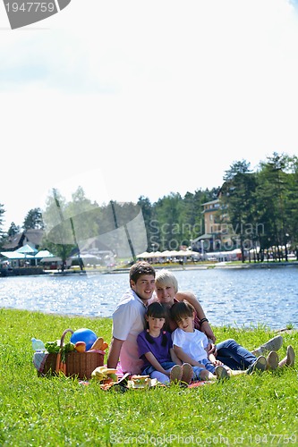 Image of Happy family playing together in a picnic outdoors