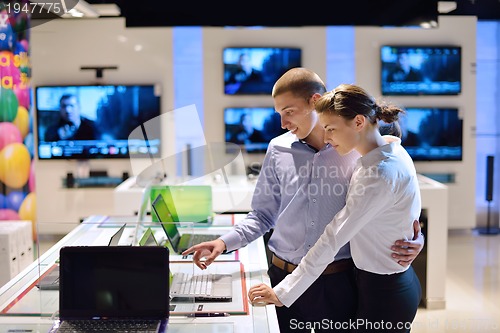 Image of Young couple in consumer electronics store