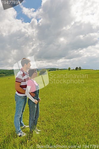 Image of Portrait of romantic young couple smiling together outdoor