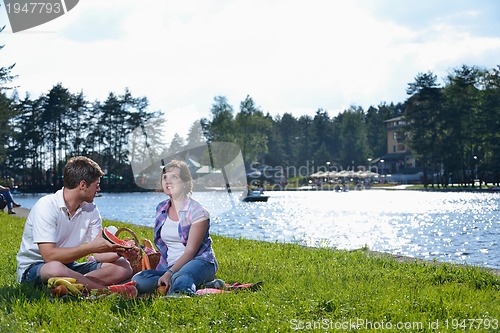 Image of happy young couple having a picnic outdoor