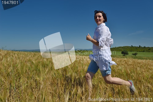 Image of young woman in wheat field at summer