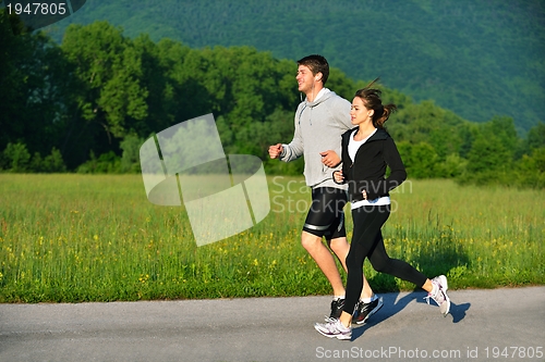 Image of Young couple jogging