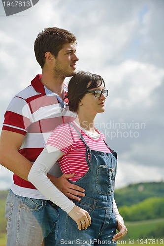 Image of Portrait of romantic young couple smiling together outdoor