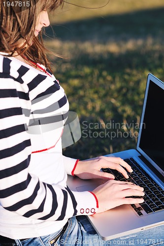 Image of young teen girl work on laptop outdoor
