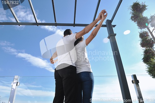 Image of couple relaxing on balcony